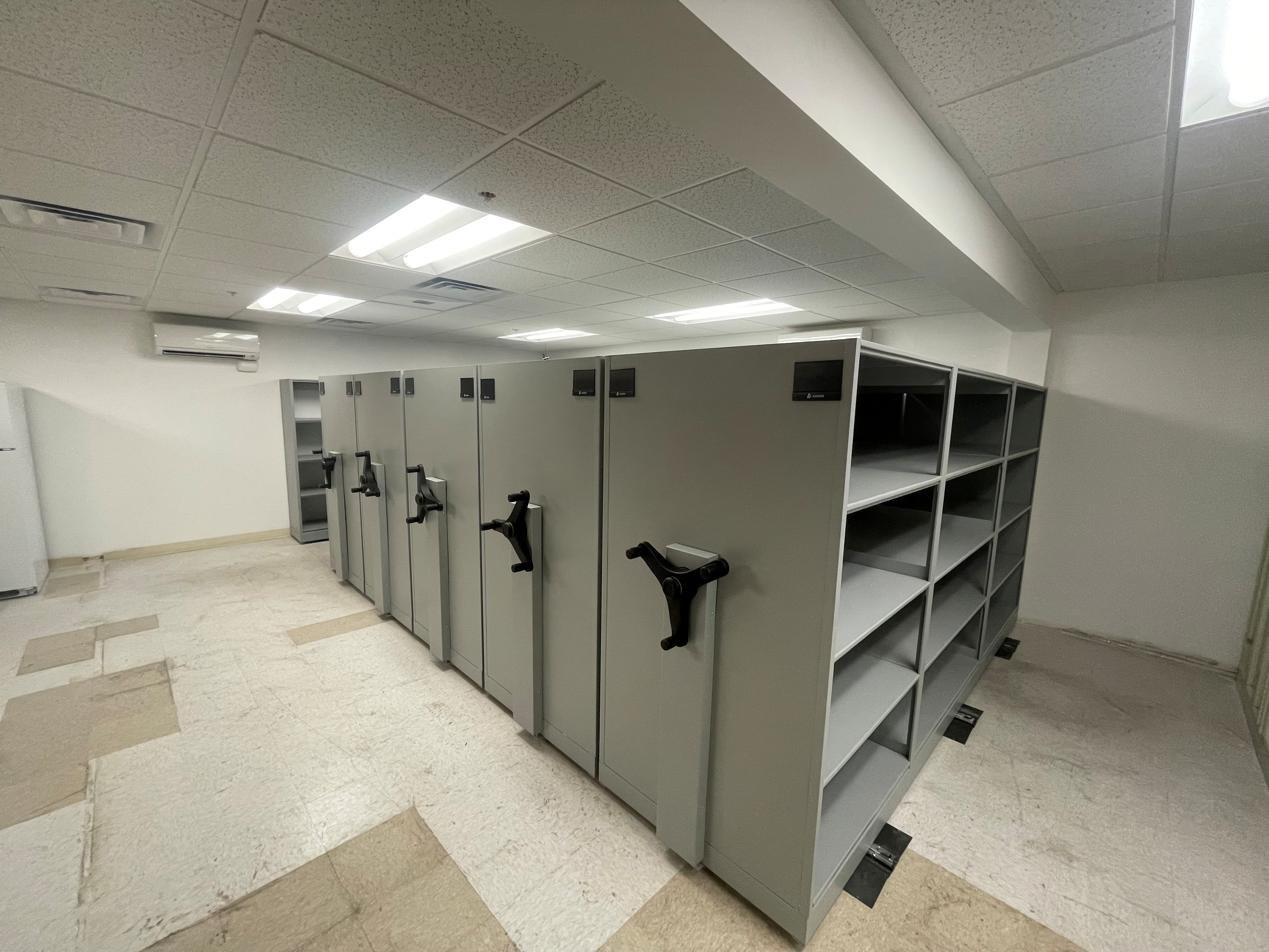 New mobile shelving system at Roy Police Department showing organized evidence storage with mechanical assist handles