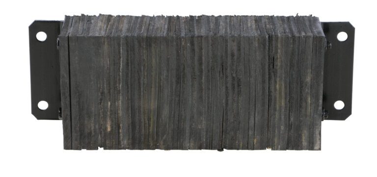 A rectangular bundle of flat, black plates, resembling sheets of graphite, is secured by metal brackets on both sides to form a block akin to the Vestil Laminated Dock Bumper 10 X 24 X 4.5 In, with rough edges and even alignment.