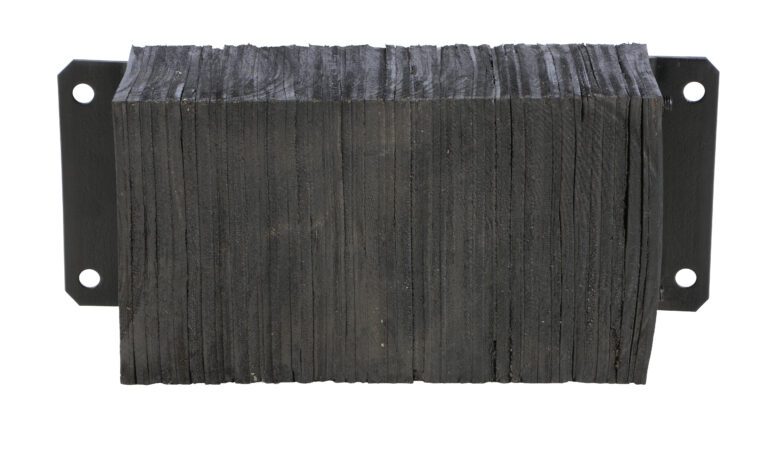 The Vestil Laminated Dock Bumper 12 X 24 X 6 In features rigid, compressed dark rubber layers stacked between two metal plates, each with four mounting holes.