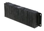 A rectangular block with compact black bristles, similar to a brush or scrubbing tool, is securely mounted on a metal bracket, much like the robust design of the Vestil Laminated Dock Bumper 12 X 36 X 4.5 In.
