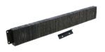 A stack of long, rectangular dark metal plates resembles the Vestil Laminated Dock Bumper 12 X 96 X 4.5 In. Beside it is a smaller black metal bracket with two holes, angled slightly to the right.