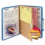 A Smead Pressboard dark blue file folder is open, showing documents clipped inside. A circular inset shows a hand touching SafeSHIELD™ fasteners labeled to protect fingers. A yellow arrow highlights a pocket divider with 2 expansion for storage. Includes 2 dividers, 10 per box (14077).