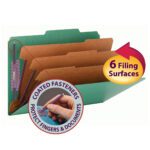 Image of Smead Pressboard Classification File Folder, legal size in green, featuring 3 dividers with different colors. It offers 6 Filing Surfaces and an inset shows a hand touching SafeSHIELD fasteners, designed to protect fingers and documents.