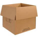 The large open cardboard box with outward-folded flaps bears black text reading 8.0 Cu. Ft. Flat Deluxe Packing Box, similar to the MH-USA 24 x 24 x 24 Deluxe Packing Boxes sold in ten-per-bundle, featuring a content-labeling grid on the side.