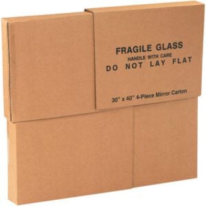 A cardboard box labeled FRAGILE GLASS HANDLE WITH CARE DO NOT LAY FLAT, holding a MH-USA 30 x 3 1/2 x 40 four-piece mirror box, stands upright against a plain background.