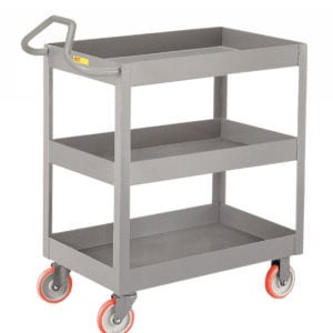 The gray utility cart resembles the Little Giant 3-Inch Deep Shelf Truck with Ergonomic Handle, featuring red wheels. Made of metal, it has three tiers, including two shelves beneath the top surface for convenient storage.