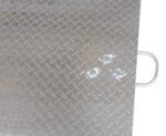 Close-up of a metallic diamond plate with bolts and a curved handle, echoing the textured grip and durability of the Vestil Aluminum Hand Truck Dockplate 0.5K 30X24.