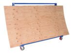 A large plywood sheet sits on a blue Vestil A-Frame Cart (2K Capacity, 36.6875 x 72 in) with wheels, against a plain white backdrop.