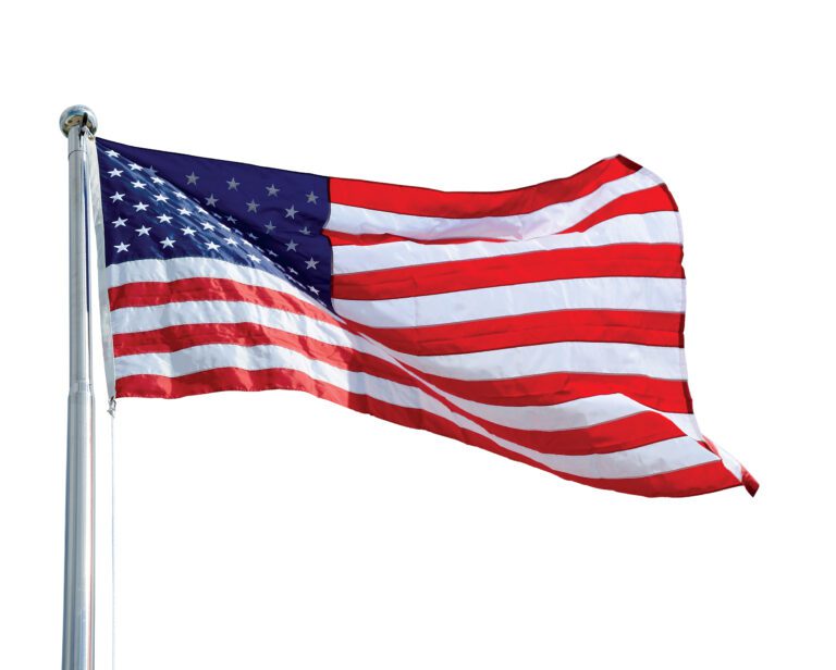 The image displays the 96W x 60H inch Vestil United States Nylon Flag, highlighting its red and white stripes with a blue field of stars at the top left, gracefully waving on a flagpole against a clean white background.