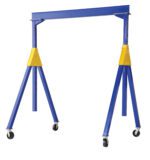 The Vestil Knock-Down Adj Steel Gantry 4K 15 X 10 is a blue and yellow adjustable crane with a horizontal beam supported by two vertical legs, triangular braces, and swivel casters, making it perfect for lifting heavy objects.