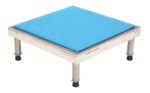 This square stool, similar to the Vestil Adj Ss Stand 10.5-16.5 H 24W X 24L, features a durable metallic frame, rubber-tipped legs for stability, and a blue cushioned seat, making it perfect for adjustable heights ranging from 10.5 to 16.5 inches with dimensions of 24W x 24L.