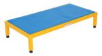 The Vestil Adj Steel Stand 10.5-16.5 H features a yellow metal frame and textured blue cushioned surface, slightly elevated with black-tipped legs, and measures 24 x 48 inches.