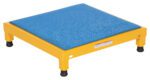 The Vestil Adjust Steel Stand 6.75-8.75 H 24 X 24 is a yellow, rectangular industrial platform with four legs and black rubber feet, featuring a blue textured mat on top. It adjusts from 6.75 to 8.75 in height, providing sturdiness and durability for various applications.