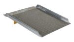 The Vestil Aluminum Hand Truck Dockboard 0.8K 30.25X47.87, with diamond tread and raised edges, bridges gaps between docks and vehicles; it features a yellow support for stability and an upward angle at one end for seamless access.