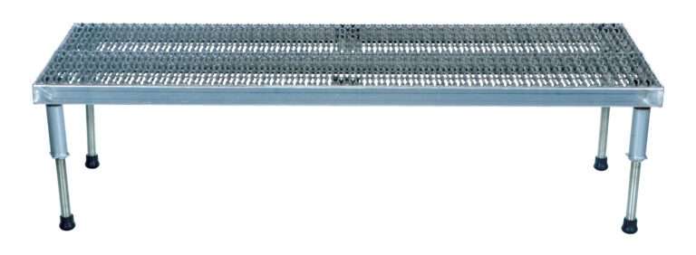 The Vestil Adj Ss Stand 10.5-16.5 H 23.5W X 60L has a metal bench with a perforated surface, four adjustable legs ranging from 10.5 to 16.5 inches in height, and measures 23.5 inches wide by 60 inches long, featuring rubber foot pads for enhanced stability.