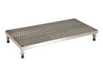 The Vestil Adj Alum Work Stand 5.75-7.75 H 19.12X35.62 features a metal platform with a diamond-patterned surface and four black rubber feet for stability, adjusting from 5.75 to 7.75 inches in height, and measures 19.12 x 35.62 inches for versatile use in various tasks.