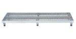 The Vestil Adj Alum Work Stand 5.75-7.75 H 23.62X72.12 features a grated metal platform on four black wheels, providing mobility and traction through small diamond-shaped openings, ideal for an industrial look suited for various tasks.