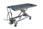 Introducing the Vestil Air SS Cart 1000 Lb 31.5X63, a durable stainless steel scissor lift table with a hydraulic mechanism, rectangular metal top, red caster wheels, and foot pedal operation. Perfect for lifting heavy items up to 1000 lbs with ease.