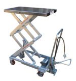 The Vestil Air SS Cart 800 lb features a silver scissor lift mechanism with caster wheels and a handle. It includes a flat, rectangular top measuring 20 x 35.5 inches and a hydraulic hose at the base for smooth lifting operations.