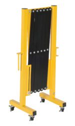 A yellow metal folding table frame with black slats, similar to the Vestil Aluminum Expand-A-Gate W/Casters, is designed for mobility with wheels at the base and can stand upright when folded.