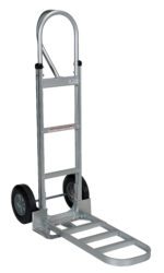 The Vestil Alum P-Handle Hand Truck Hard Rubber features a tall handle, robust silver frame, and two large black hard rubber wheels with a flat extended platform ideal for easily transporting heavy items.