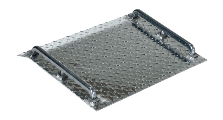 The Vestil Alum Tread Plate Mini Dockboard 600 Lb features a metal diamond plate ramp with two raised edges, providing traction on its textured surface and supporting up to 600 lb. Its reflective metal finish is shown at a slight angle in the image.