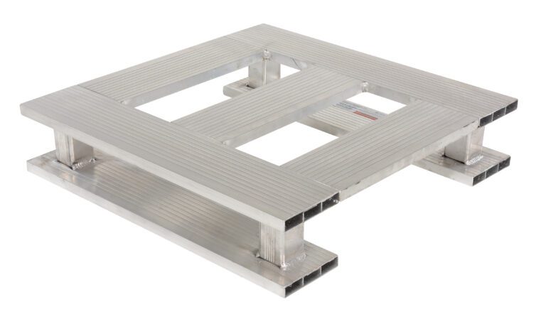 The Vestil Heavy Duty Aluminum Half Pallet Skid Bottom 24X24 boasts a sturdy, square slatted design with a durable metallic surface, reinforced by four strong horizontal beams and an open center, ideal for industrial use or transportation.