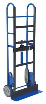 The Vestil Appliance Cart Ratchet 750 Lb is a blue hand truck with two wheels and a rectangular base, capable of transporting up to 750 lbs. Its metal frame has black straps and grips for secure loading, making it ideal for moving appliances efficiently.