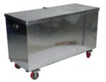 The Vestil Aluminum Tool Box-Casters 24 X 60 offers a large, rectangular design with a diamond plate texture, reflective metallic finish, and four red caster wheels. It includes a hinged lid for convenient access in industrial storage settings.