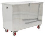 The Vestil Aluminum Tool Box-Casters 36 X 60 features a diamond plate finish, four red caster wheels, a hinged lid, side handles, and a secure front lock. Its spacious and silver in color, set against a plain white background.