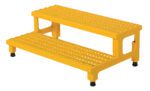 The Vestil Adjust Step Mate Stand 2 Step 36.18 x 22.87 in is a durable, yellow industrial stair platform with two steps featuring perforated, slip-resistant surfaces, adjustable black feet, and side handles for easy portability.