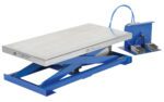 The blue Vestil Pneumatic Scissor Lift Table 400 Lb boasts a durable steel platform and comes with a control box featuring two foot pedals linked by a blue cable for effortless height adjustment.