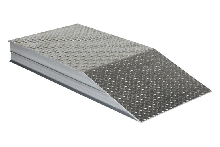 A metal ramp with a diamond-patterned surface resembles the Vestil Heavy Duty Alum Wheel Riser 24X5.93X48, providing a gentle incline for smooth loading or elevating of objects over short heights.