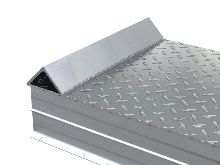 A close-up of the metallic toolbox reveals its patterned, corrugated lid with a diamond plate texture similar to the Vestil Alum Tread Whl Riser W/ Roll Of Guard 108X18X8. The lids triangular, raised edge indicates its partially open, and the shiny metal surface is reflective.