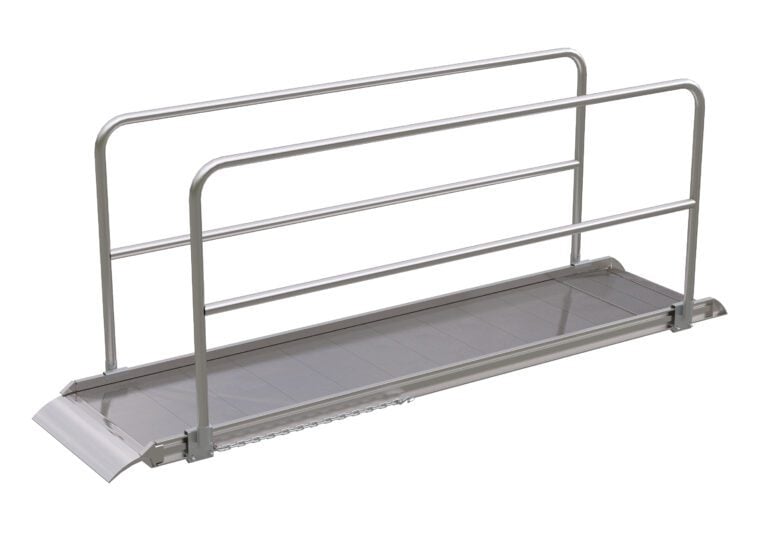 The Vestil Alum Walk Ramp Handrail Overlap, 120 x 28 inches, features a metallic finish and robust side rails. Its textured surface and sloped end improve accessibility, while the minimalist design contrasts against a white backdrop.