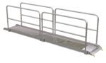 The temporary metal pedestrian bridge, measuring 145.43 x 28 inches, has grated surfaces and a slight incline at one end. It features Vestil Alum Walk Ramp Handrail Hooks for safe passage with handrails on both sides.