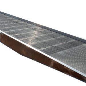 The Vestil Aluminum Yard Ramp 16K Lb 86W X 360L In has a grated surface, slight incline, and solid base for stable loading of heavy equipment or vehicles onto trucks or platforms.