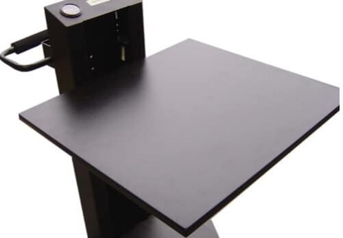 A black podium with a flat top surface, suitable for holding papers or electronic devices during a presentation. It features a microphone and a control panel on the side, and a handle for mobility.