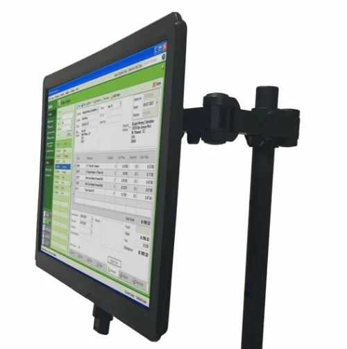 Side view of a flat computer screen mounted on a vertical stand. The display shows a software interface with a green and white color scheme, featuring a window with data entries and columns visible on the screen.