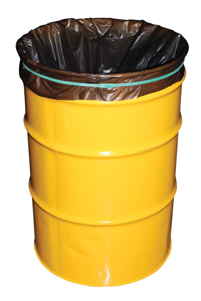 A large yellow metal barrel, lined with a black plastic trash bag at the top, is secured by a Vestil Jumbo Rubber Bands-Drum 17 In Long. The smooth surface and two visible horizontal bands make it practical and efficient for waste management.