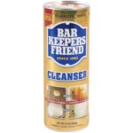 The Bar Keepers Friend Powder - 21 oz., sold in cases of 12, features a gold-labeled cylindrical container showcasing its cleaning effectiveness for bathrooms, kitchens, and cookware with before-and-after images.
