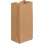 The 5 1/4 x 3 7/16 x 10 15/16 Kraft Grocery Bags (500/Case) stand upright with a flat bottom, open top, and slightly creased sides, making them perfect for groceries or lunch.