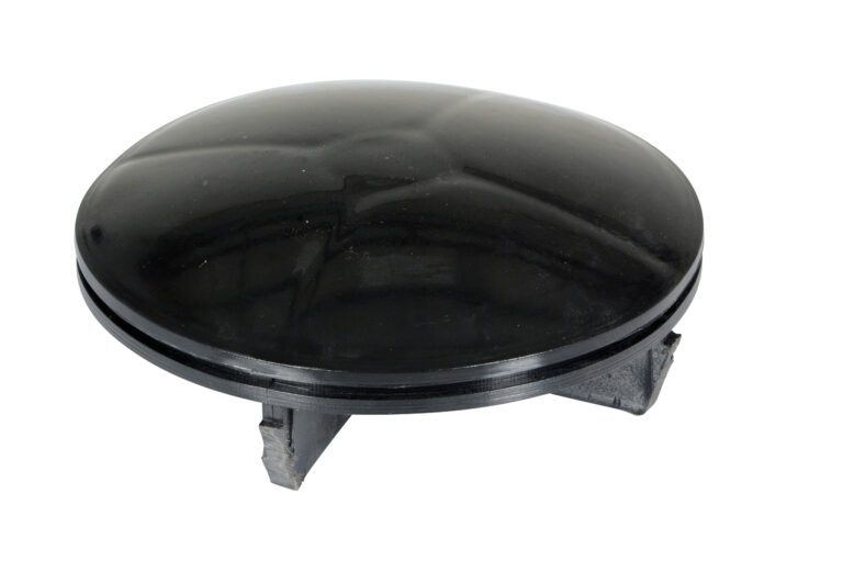 BOL-CAP-5.5-P_A.jpg A black, round object with a glossy domed surface resembles the Vestil Bollard Cap Plastic Replacement 5.5 In. Elevated by three dark gray legs, it looks like a small UFO or dome sitting at an angle.