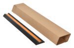 An open, long rectangular cardboard box on a white surface contains the Vestil Extruded Rubber Bumper Stop 36L next to a black protective casing with an orange interior.