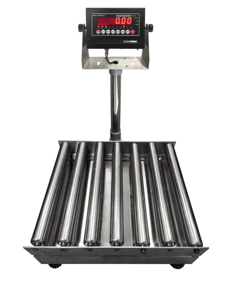 The Vestil Bench Scale SS Tray Roll Top 24x24 1000 includes a digital display with red numbers and multiple control buttons. It has a platform of parallel metal rollers for weighing large objects, with the display mounted on a vertical stand attached to the base.