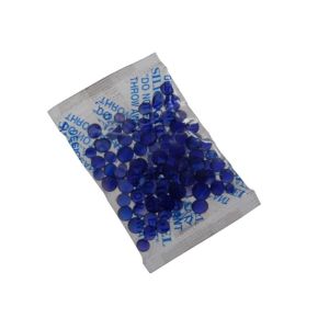 A small packet of Vestil Moisture Absorbing Blue Silica 3000 Pcs contains tiny blue crystals, visible through a transparent side, with informational text on the other side in matching blue font.