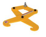The Vestil Beam Tongs 1 Ton 6 In Max Beam Width clamp features two curved hooks and a central attachment point. It includes a caution label, small American flag sticker, and its yellow metal finish contrasts with the white background.
