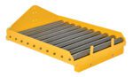 The Vestil Battery Transfer Platform includes a yellow metal roller conveyor section with multiple cylindrical rollers and a triangular end plate.