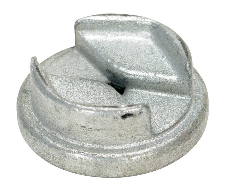 A round silver metal object with a flat base and two raised curved sections on top, resembling the Vestil Zinc Drum Bung Socket 3/8 In Drive, rests on a white background, showcasing its textured surface.