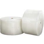 Two large MH-USA 1/2 x 24 x 250 (2) Strong Grade Air Bubble Rolls stand upright against a white background. Their textured surfaces with visible bubbles ensure optimal packing and protection for shipping, offering reliability at 250 feet per roll.